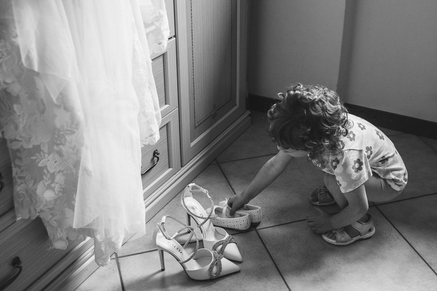 A Little Baby Places Her Shoes Next To Her Mother's On Her Wedding Day