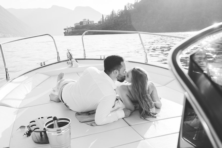 A Young Couple Kisses On A Boat In Lake Como after wedding proposal