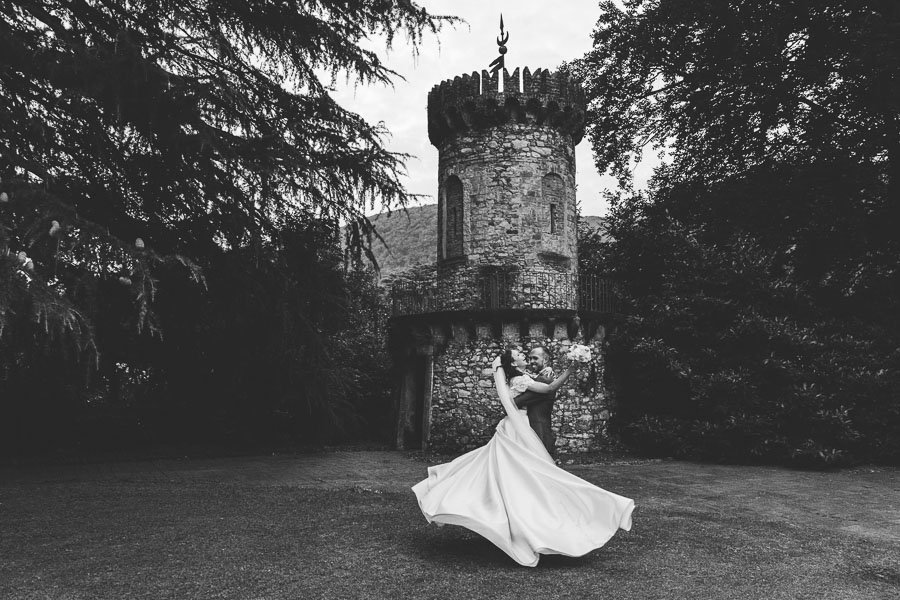 The Husband Spins The Bride In A Dance under a tower