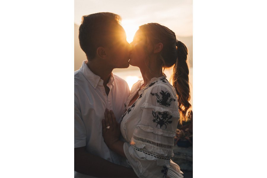 Two New Fiancés Kiss Between Sun Rays in lake como