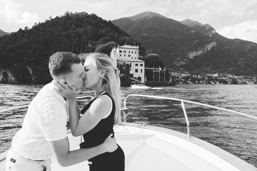 Two Young American Fiancés They Kiss After Proposal in front of villa balbianello on lake como